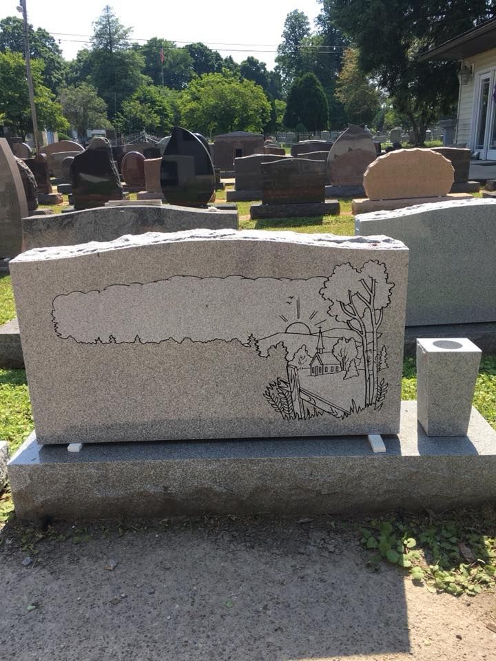 A gravestone with a drawing of a tree on it