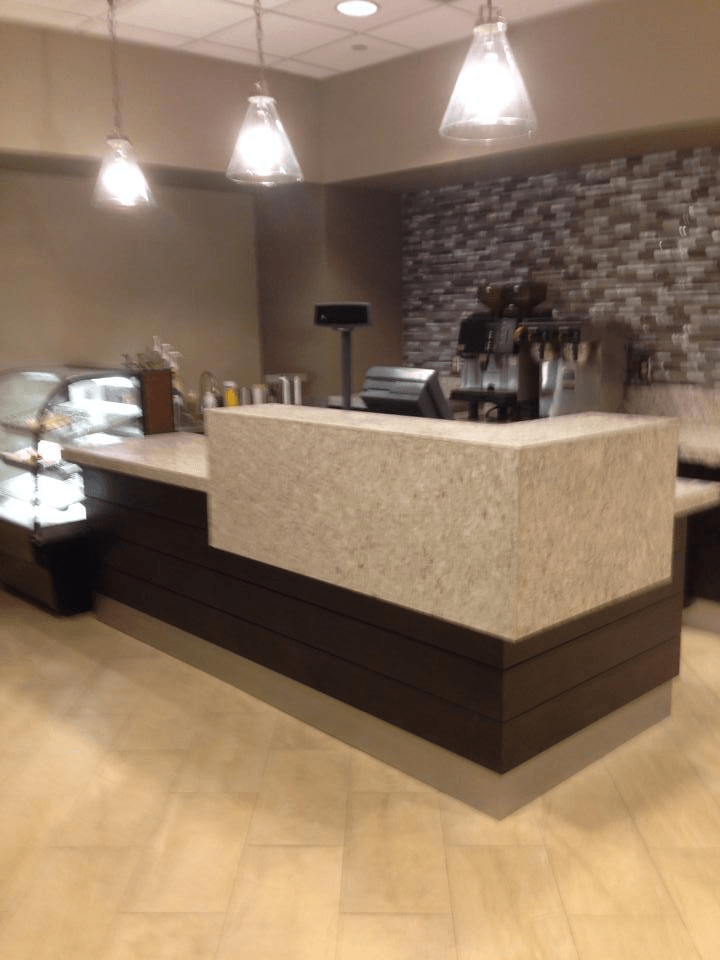 A restaurant with a long counter and a display case