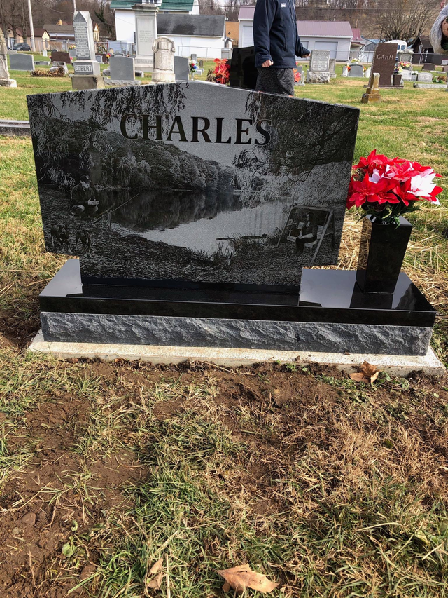 A black gravestone with the name charles on it