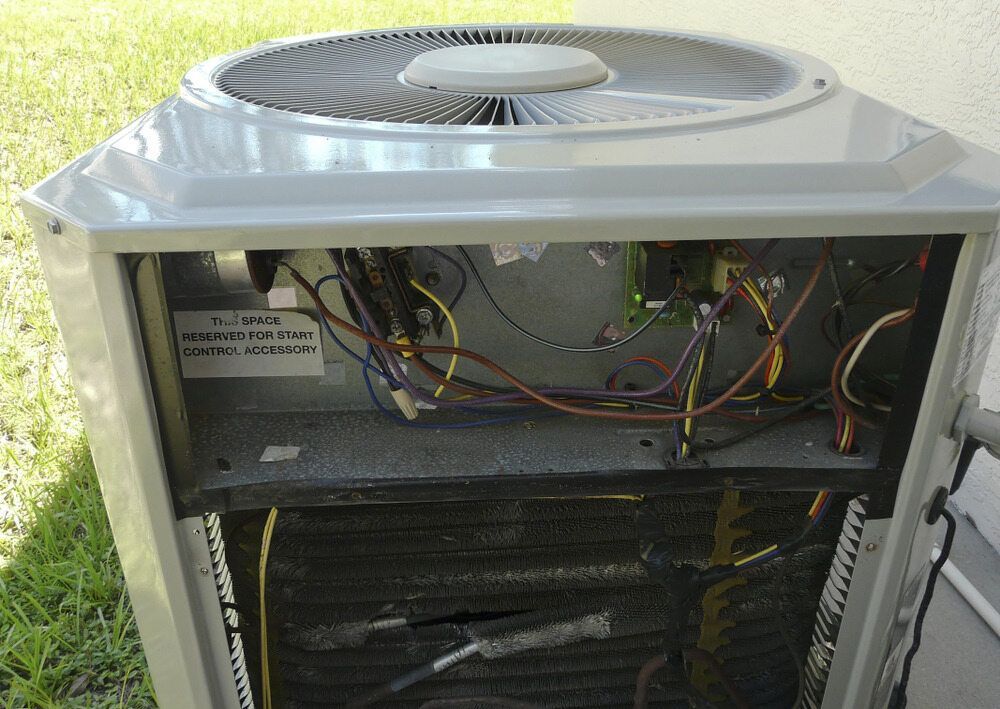 Open Air Conditioning Unit With Visible Wiring, Fan, and Coils — Hunter Fire & Safety in Edgeworth, NSW