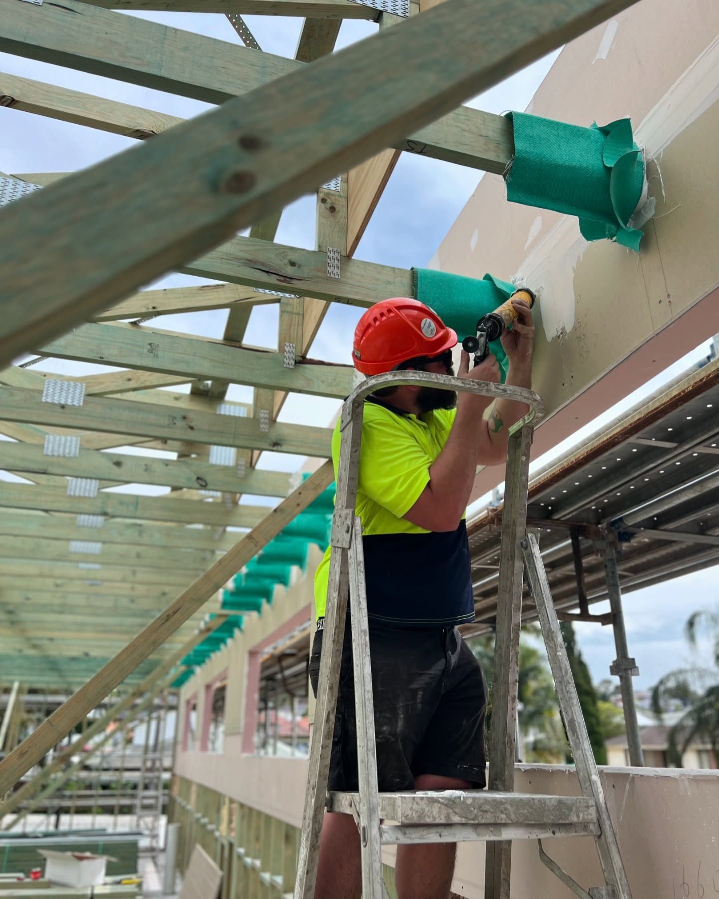 Construction Worker in Hard Hat Using a Tool — Hunter Fire & Safety in Central Coast, NSW