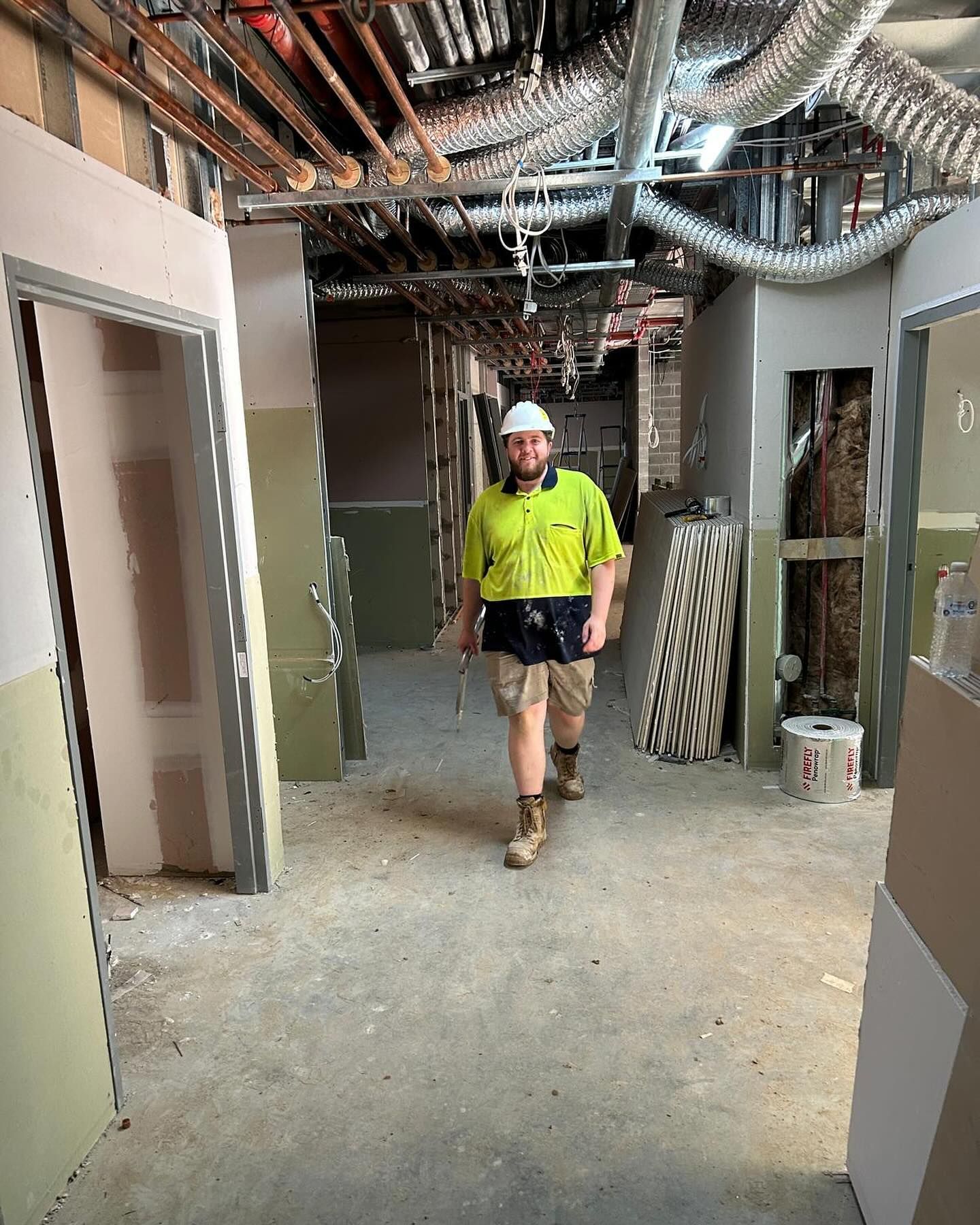 Construction Worker in a Hallway Under Renovation — Hunter Fire & Safety in Port Macquarie, NSW