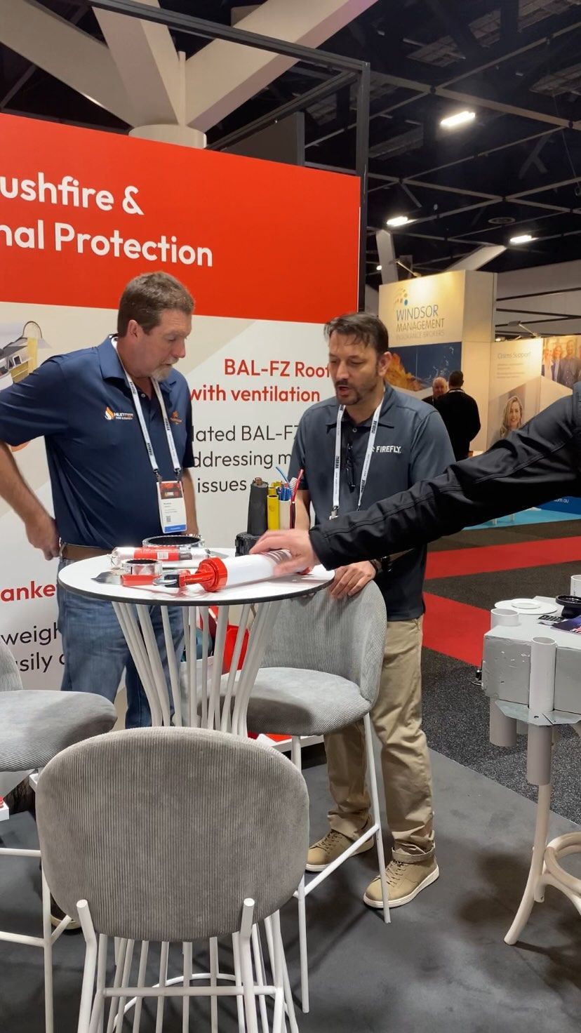 Two Men at Trade Show Booth — Hunter Fire & Safety in Edgeworth, NSW