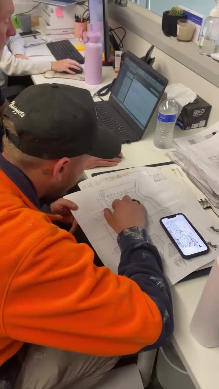Man in Orange Shirt at Desk — Hunter Fire & Safety in Edgeworth, NSW