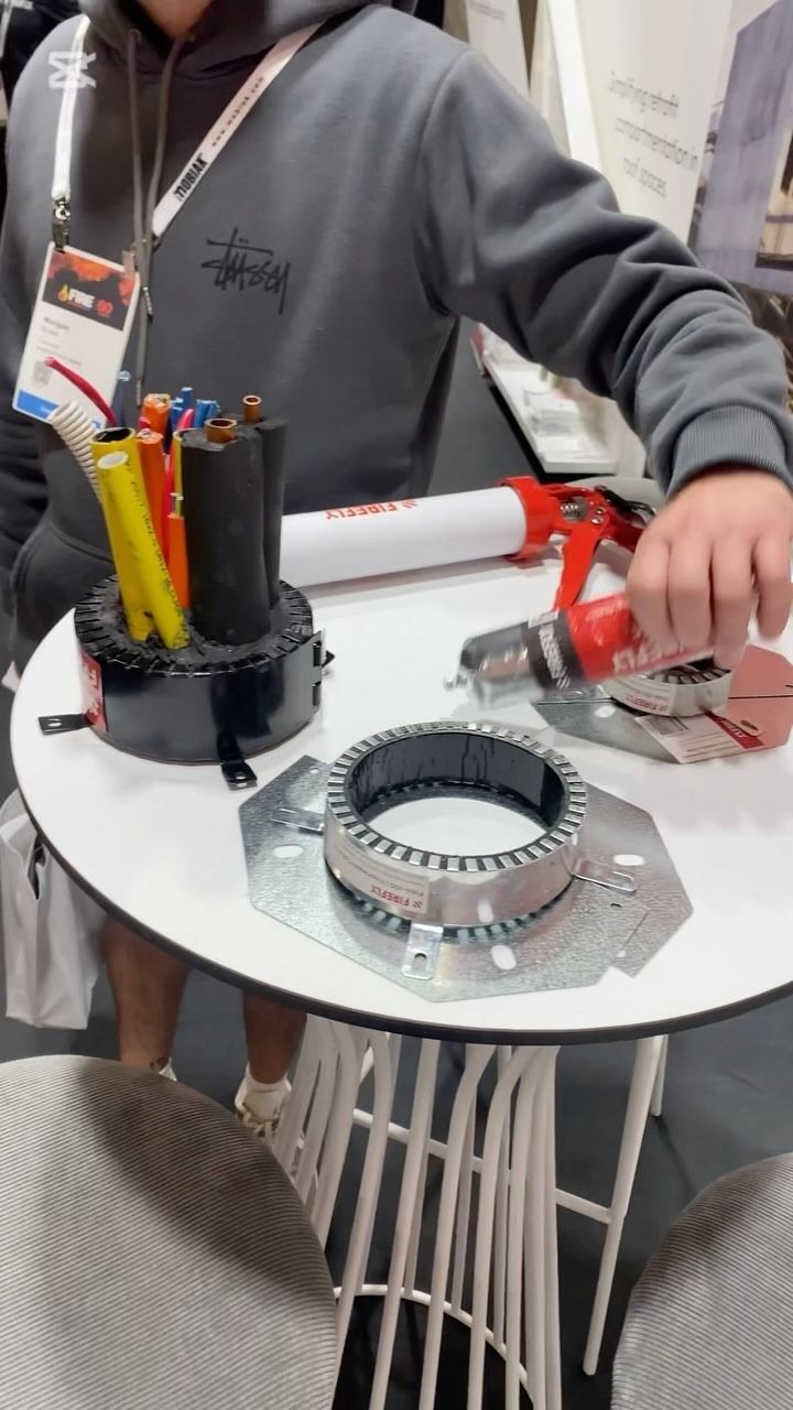 Person Demonstrating Cable Installation at a Tradeshow Booth — Hunter Fire & Safety in Port Macquarie, NSW