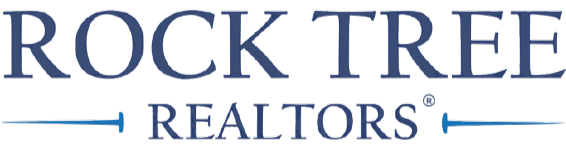 Logo for Rock Tree Realtors. Blue text on white background with blue horizontal lines.