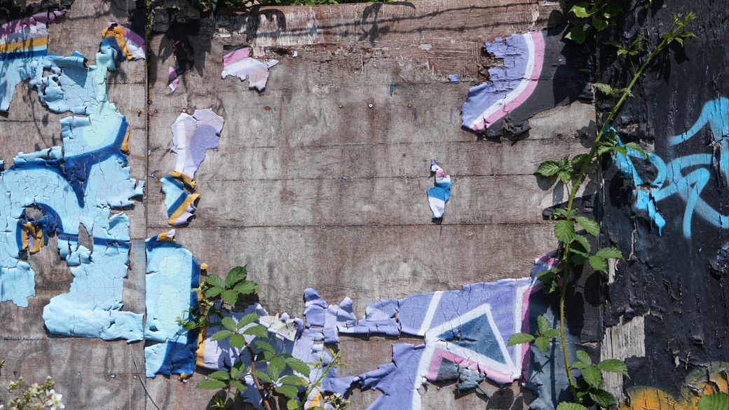 A wall with a lot of graffiti on it