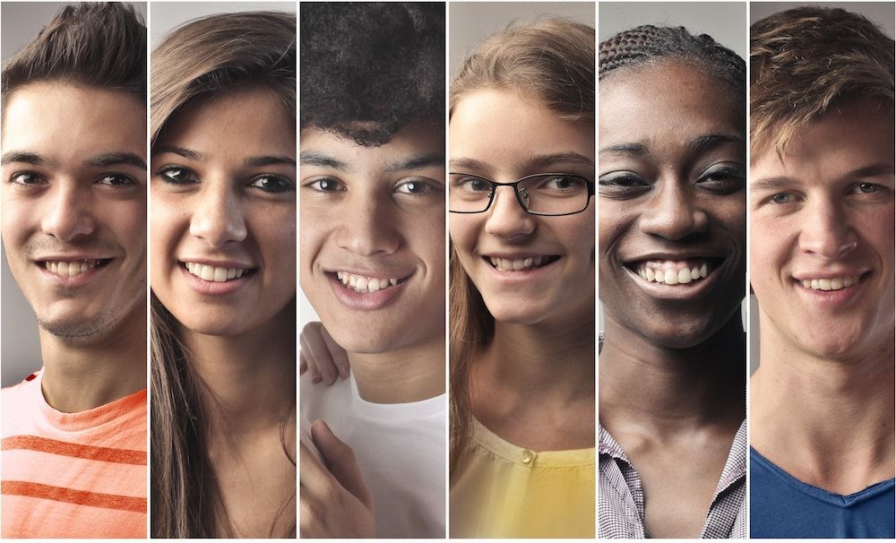 A group of young people are smiling for the camera.