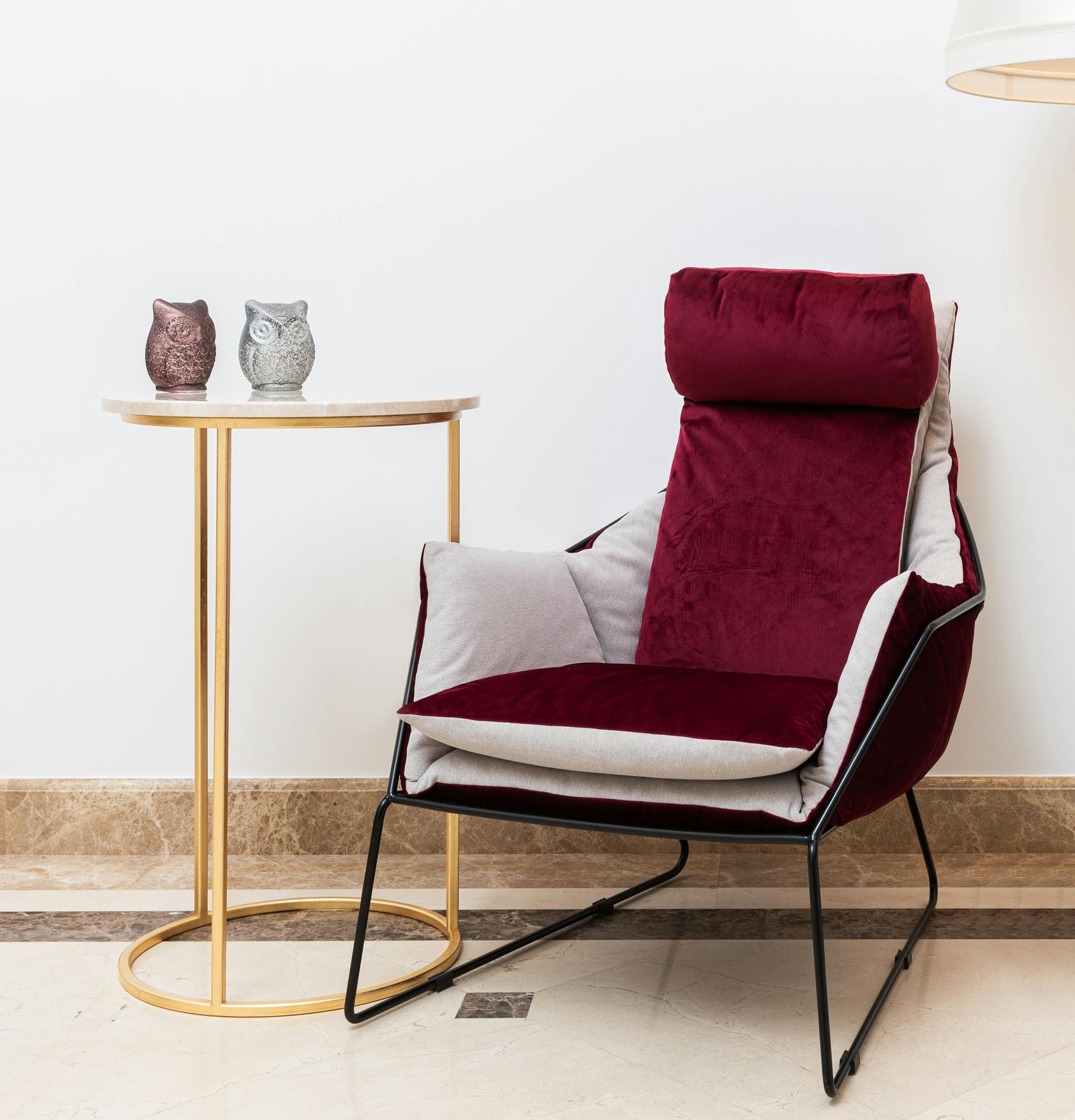 A red chair is sitting next to a small table