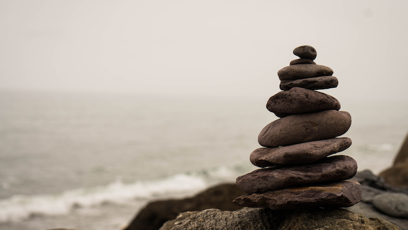 A pile of rocks stacked on top of each other on a beach.