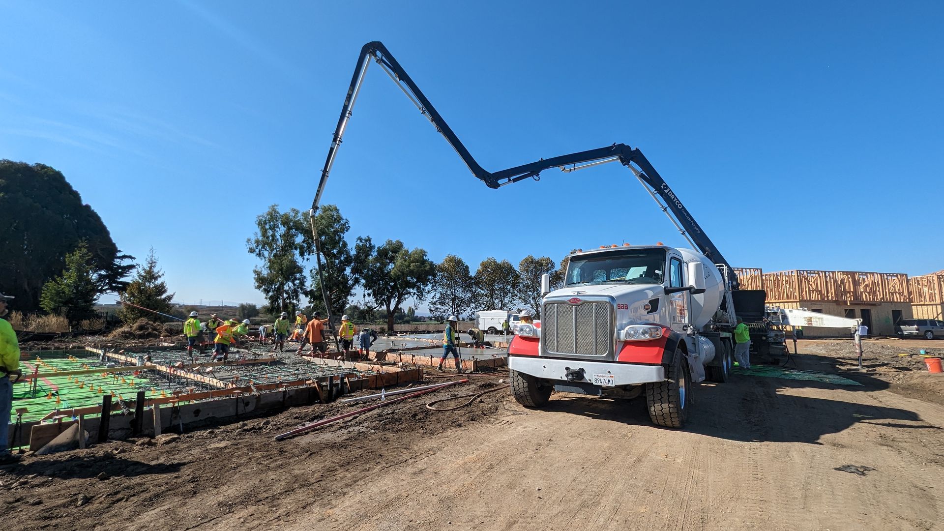 SBS concrete truck and concrete pump on a job site.