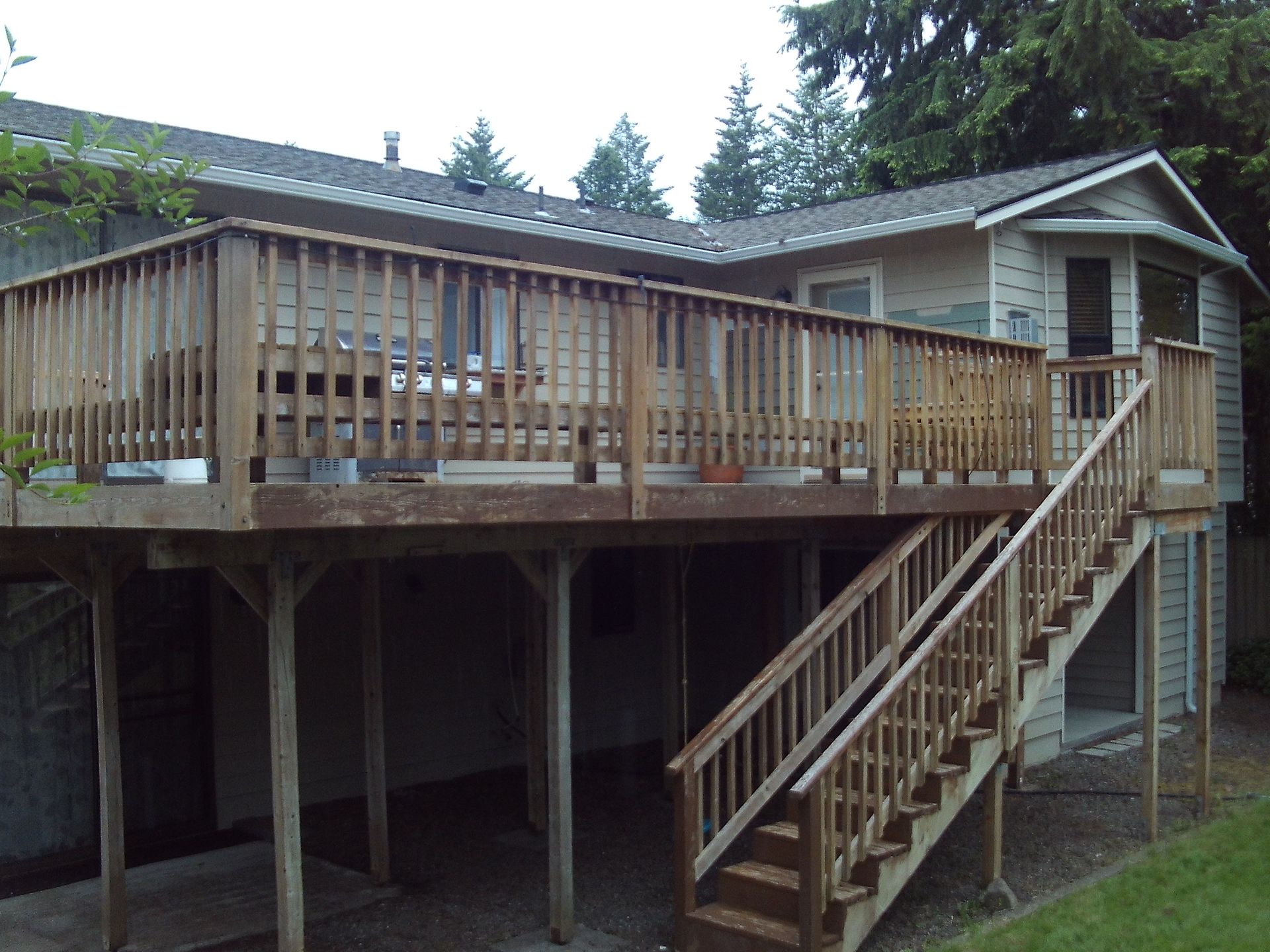 A house with a large deck and stairs leading up to it