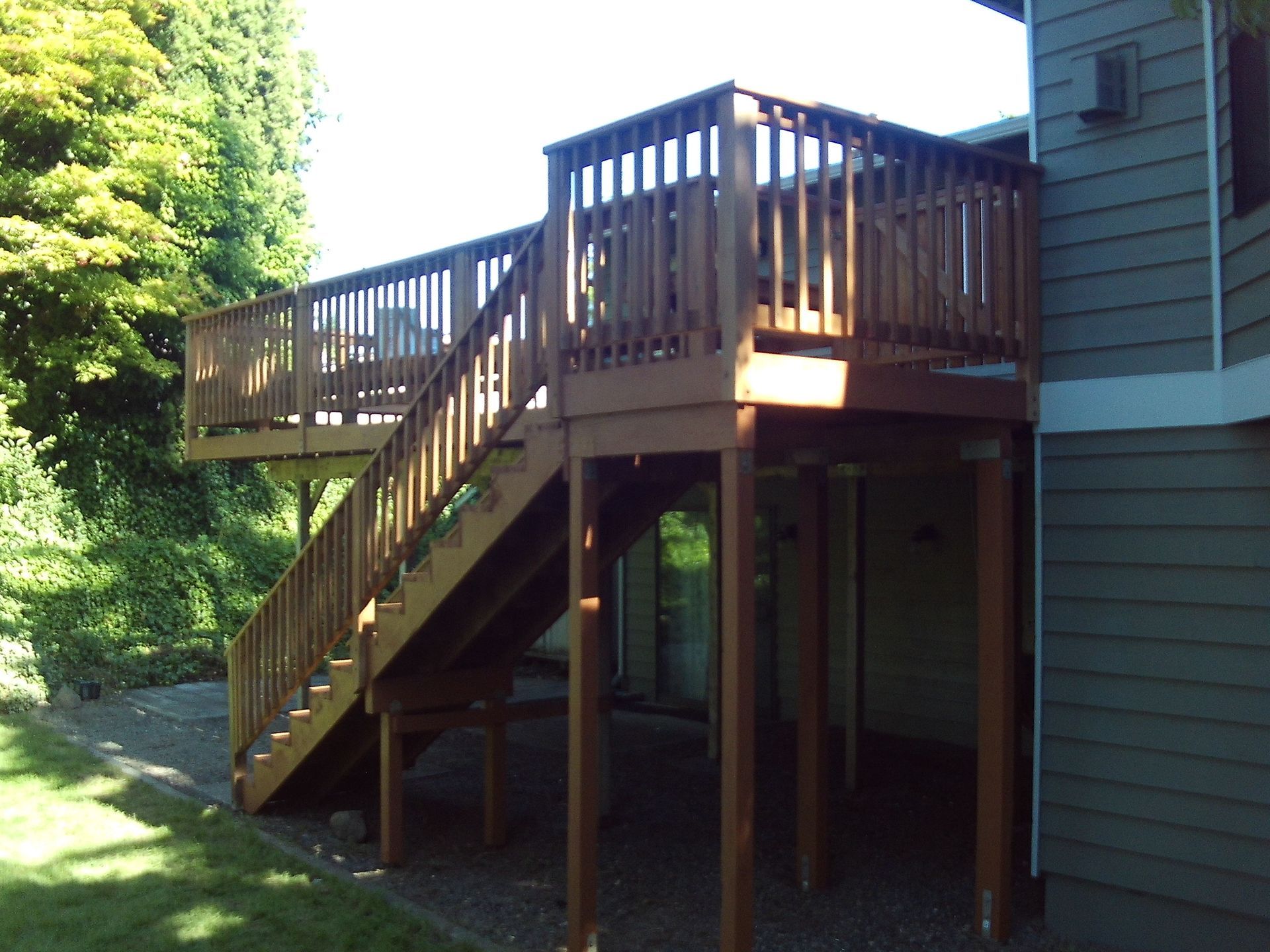 A wooden deck with stairs leading up to it