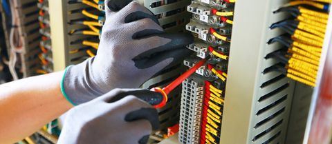 Commercial Electrician — Electrician Inspecting the Electrical Panel in Venice, FL