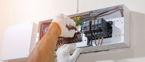 Residential Electrician — Electrician Fixing the Breaker Box in Venice, FL