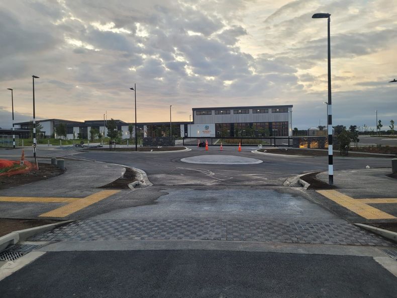 An empty parking lot with a building in the background