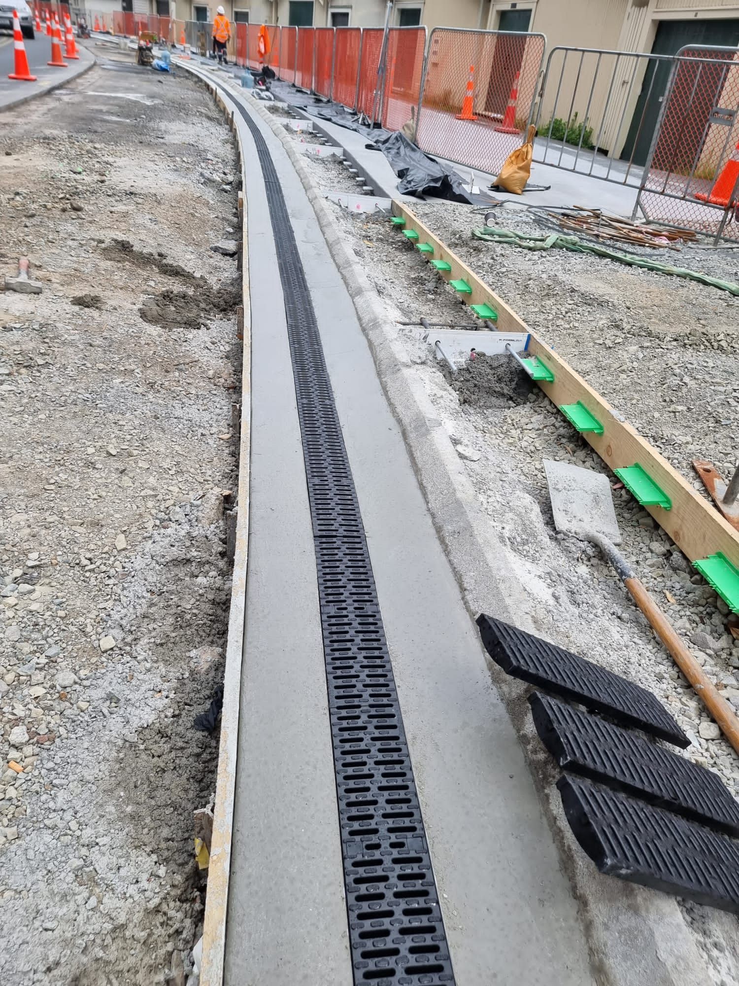 A drain is being installed on the side of a road