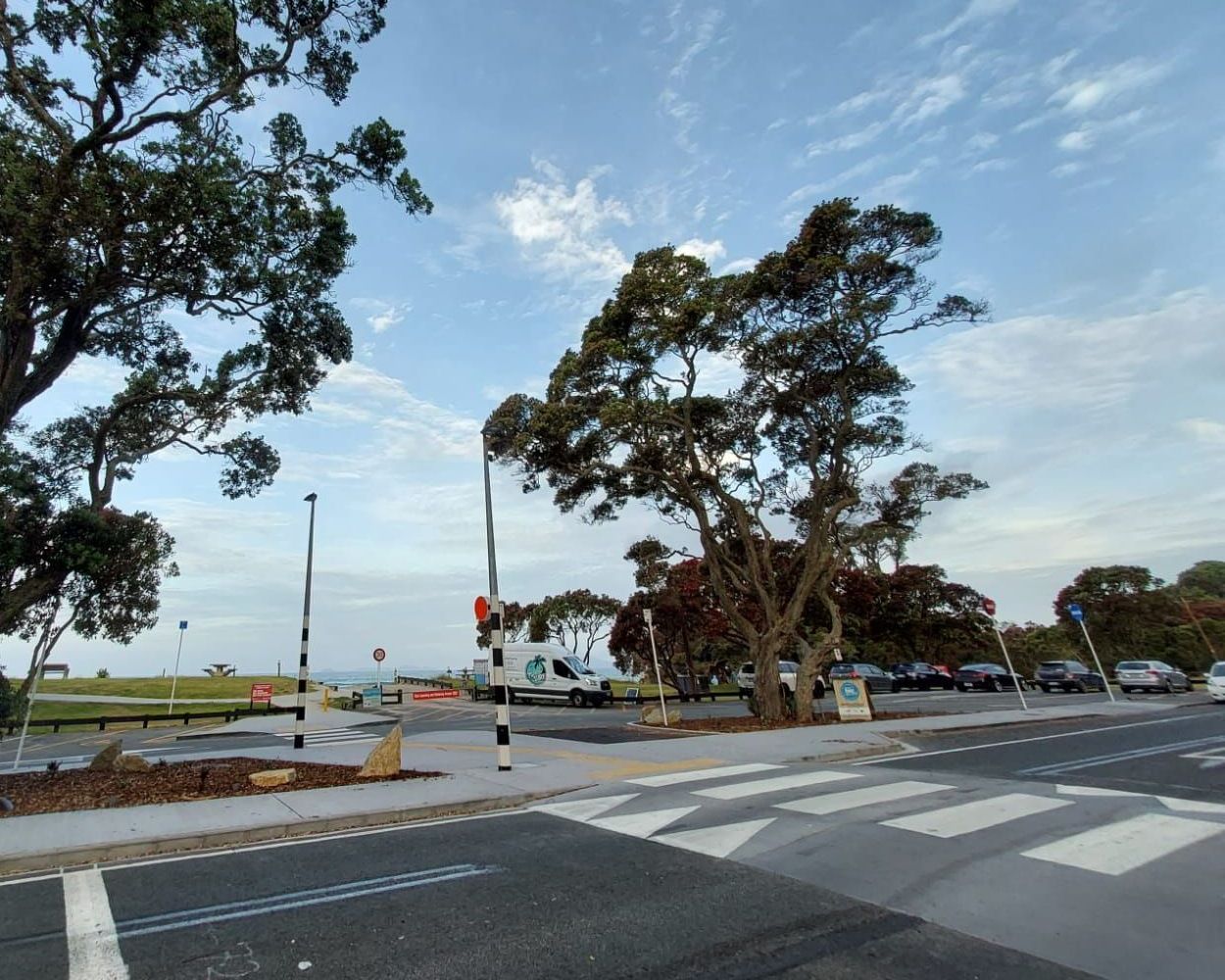 A busy street with trees on the side of it