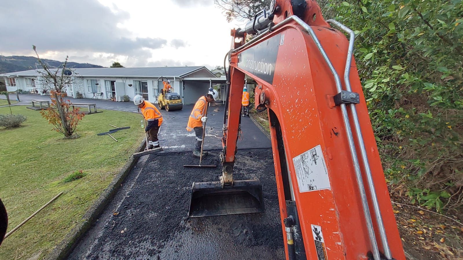 A group of construction workers are working on a road.