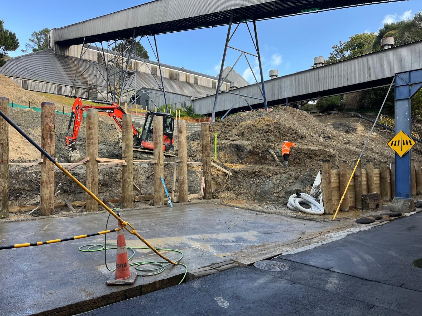 A construction site with a bridge in the background.