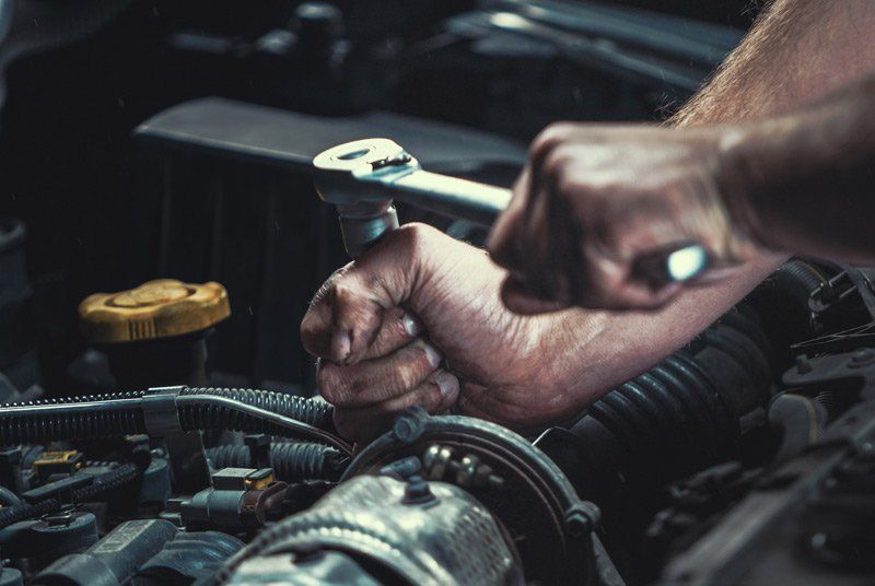 mechanic working on car engine