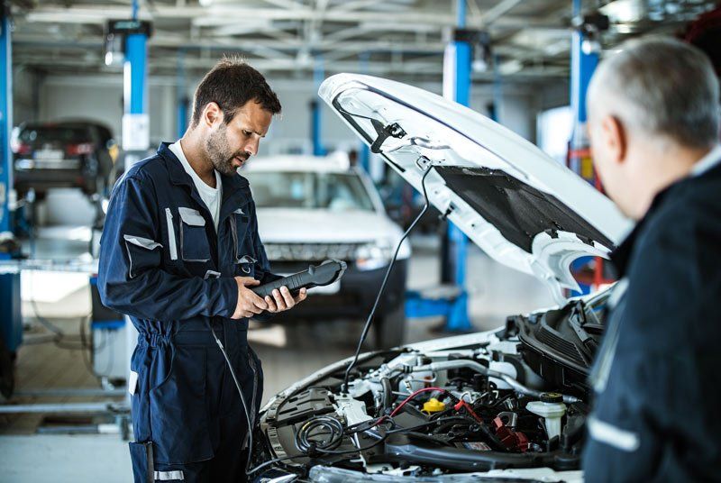 mechanic using auto diagnostic tool