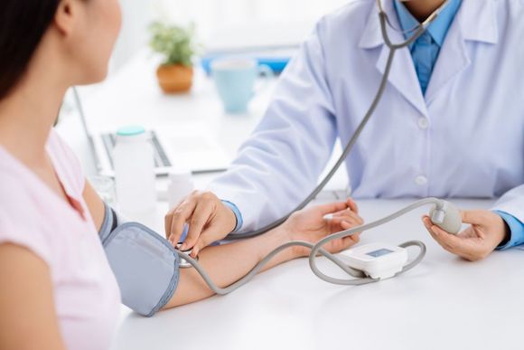 doctor checking BP of the patient