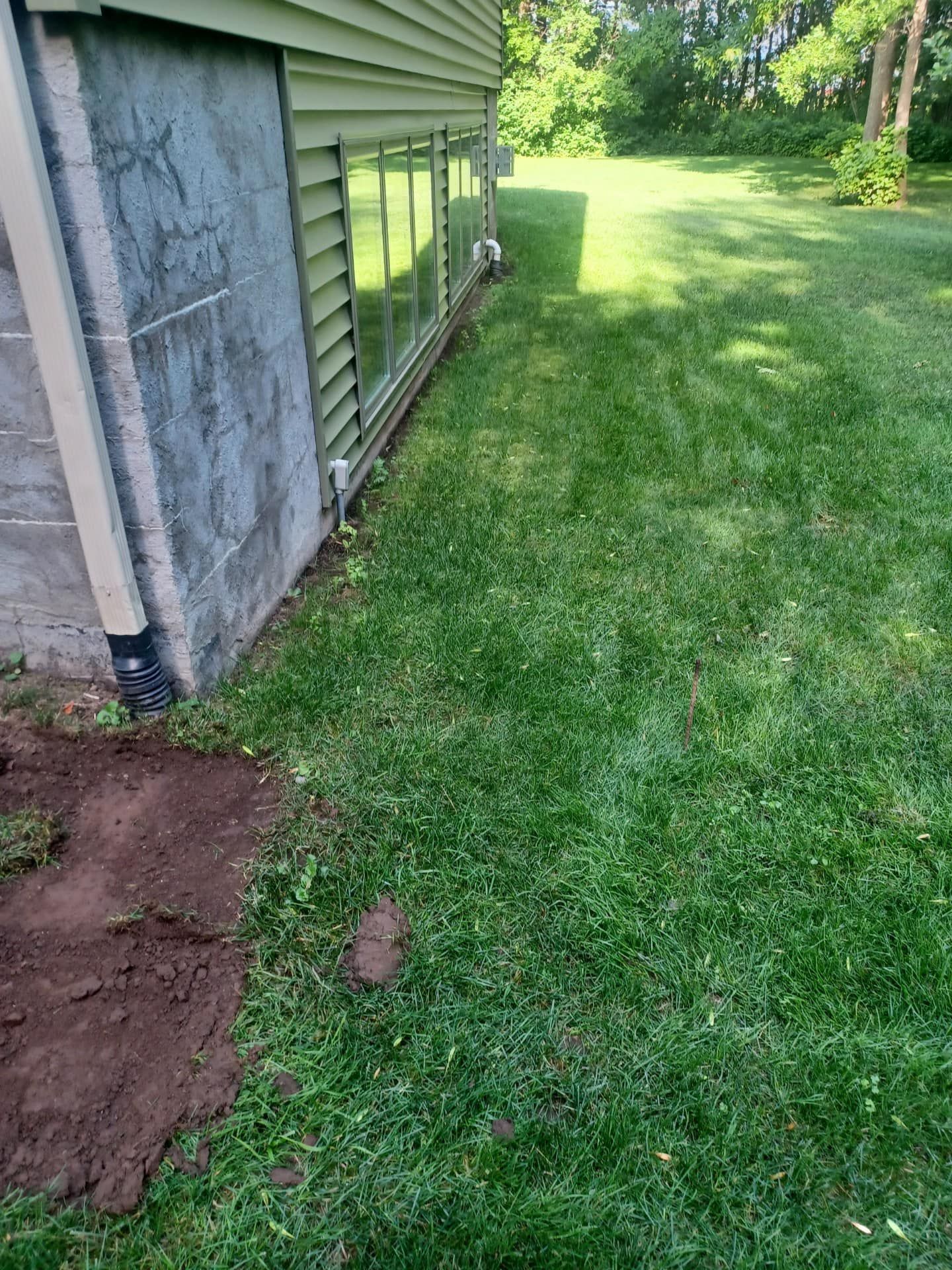 A house with a lot of grass in front of it.