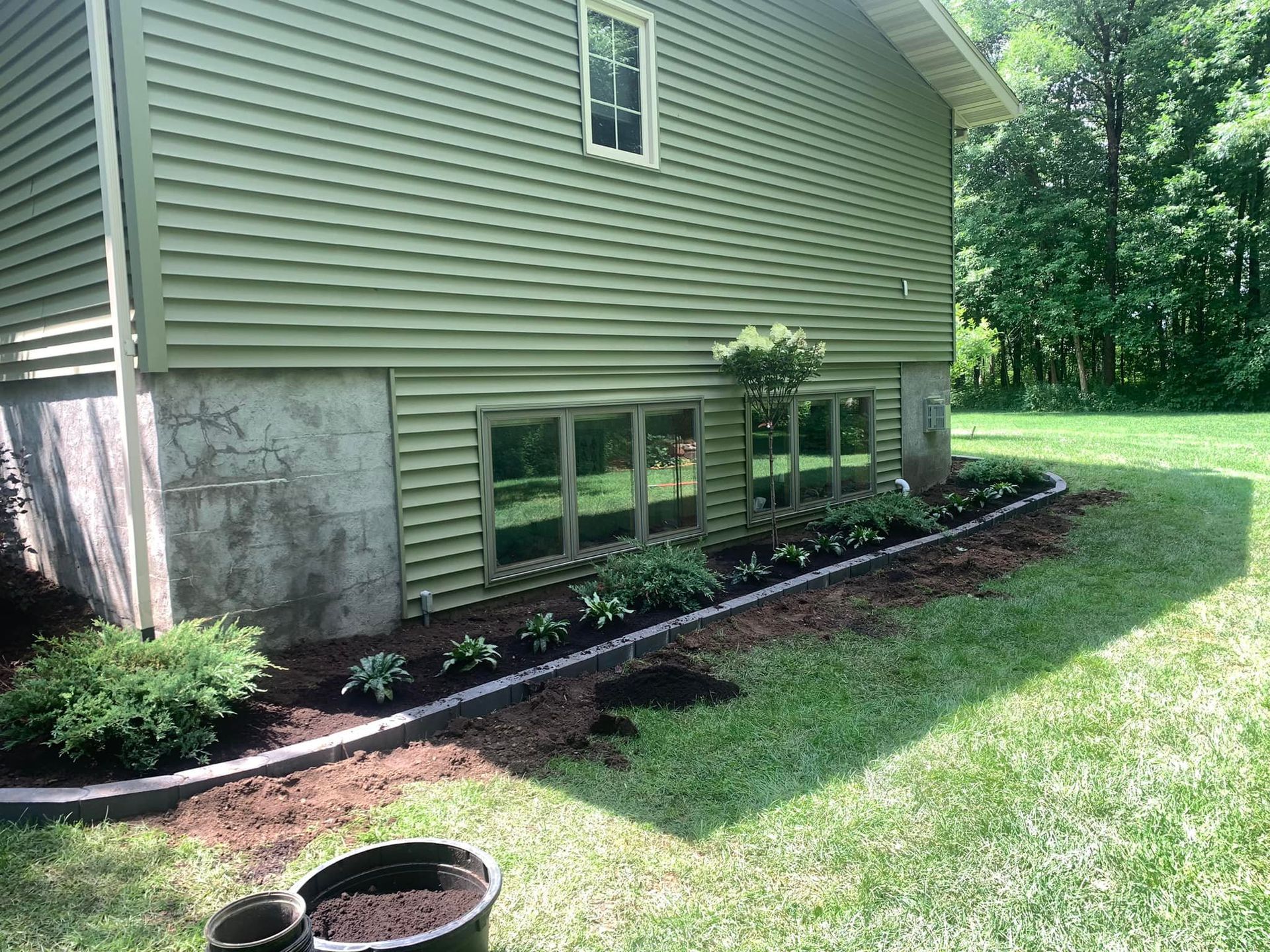 A house with a lot of plants in front of it