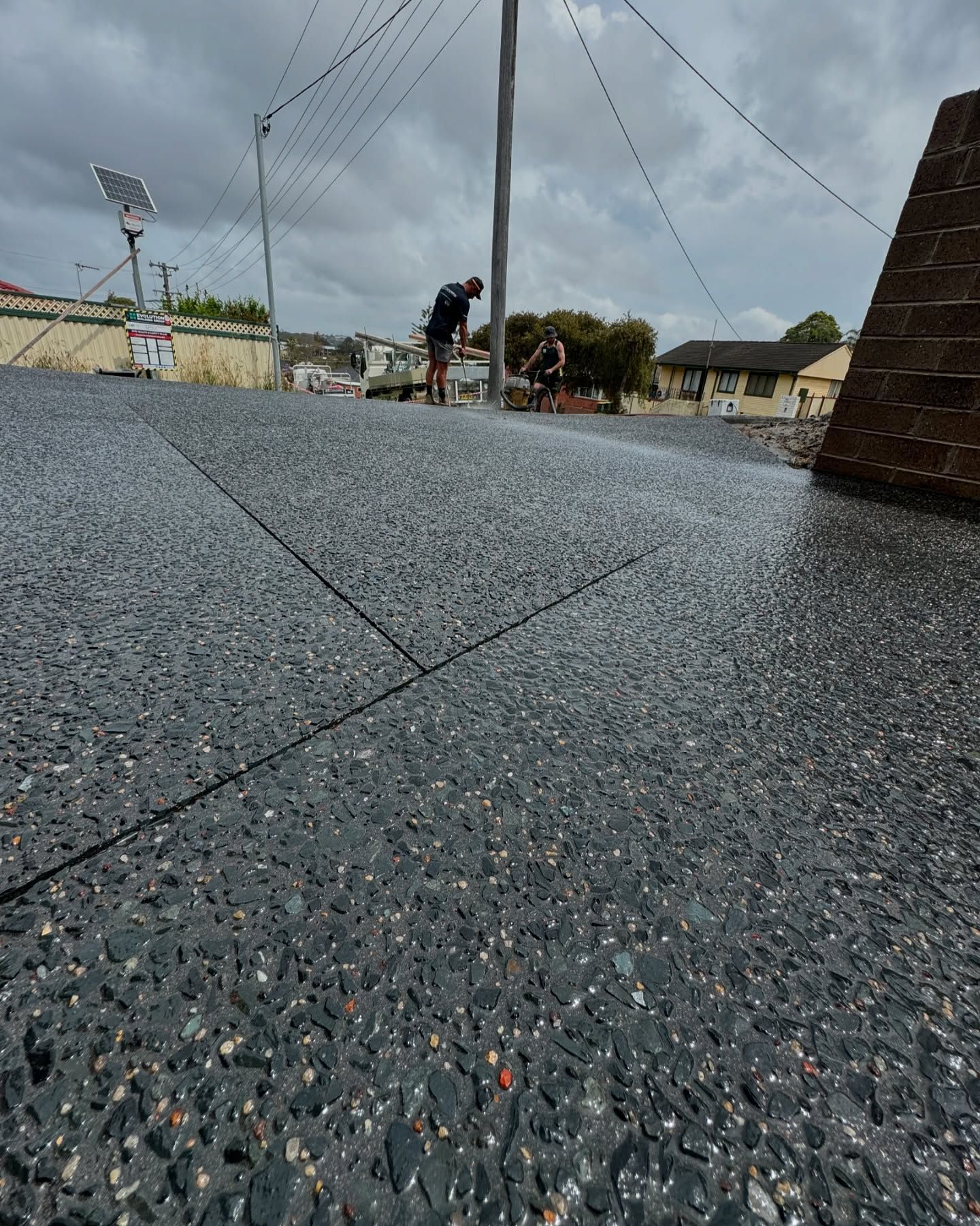 A Low-angle View of a Grey Exposed Aggregate Concrete Driveway — JDB Concreting in Southern Highlands, NSW
