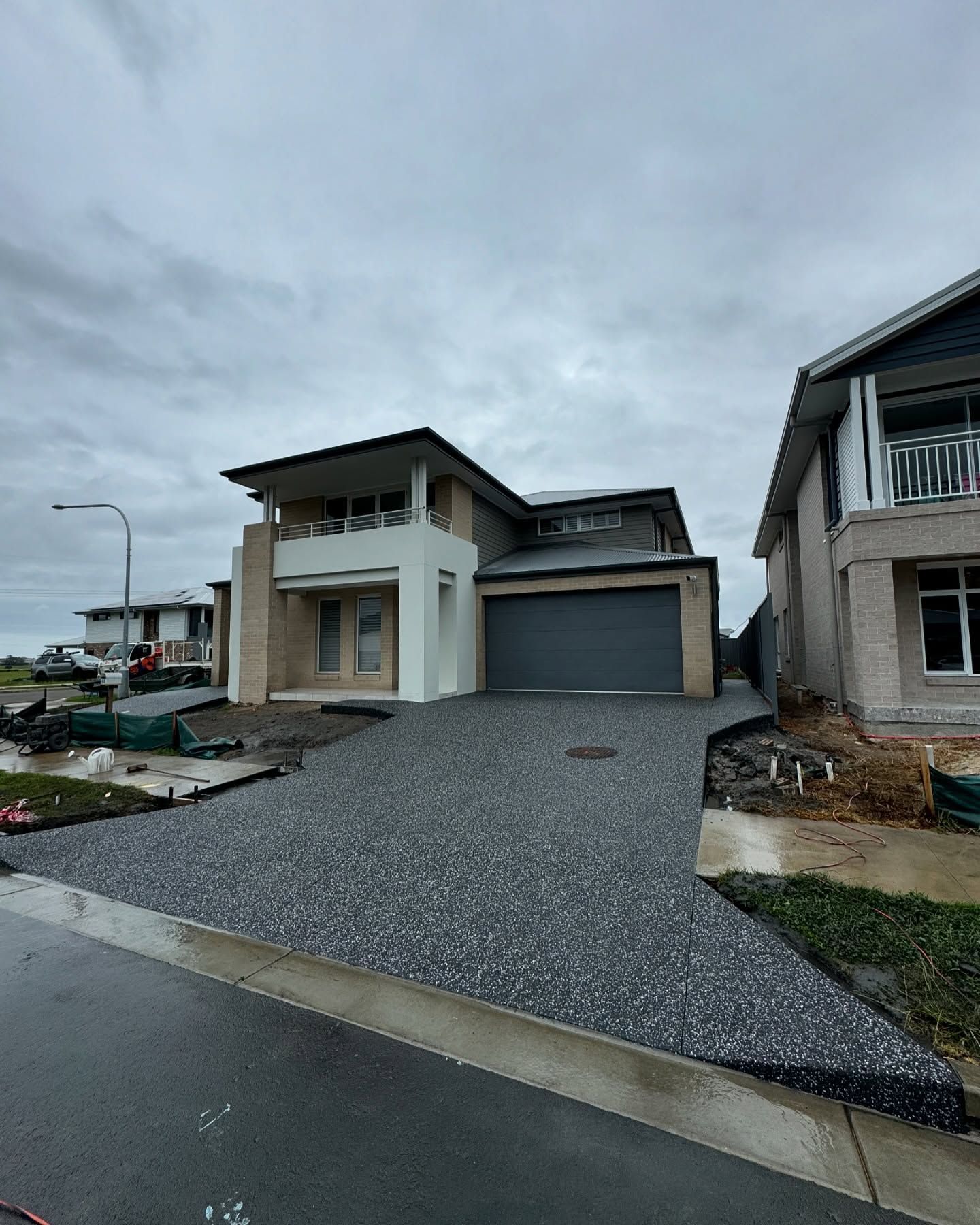 A Modern Two-story Suburban House With a Gray Garage — JDB Concreting in Robertson, NSW