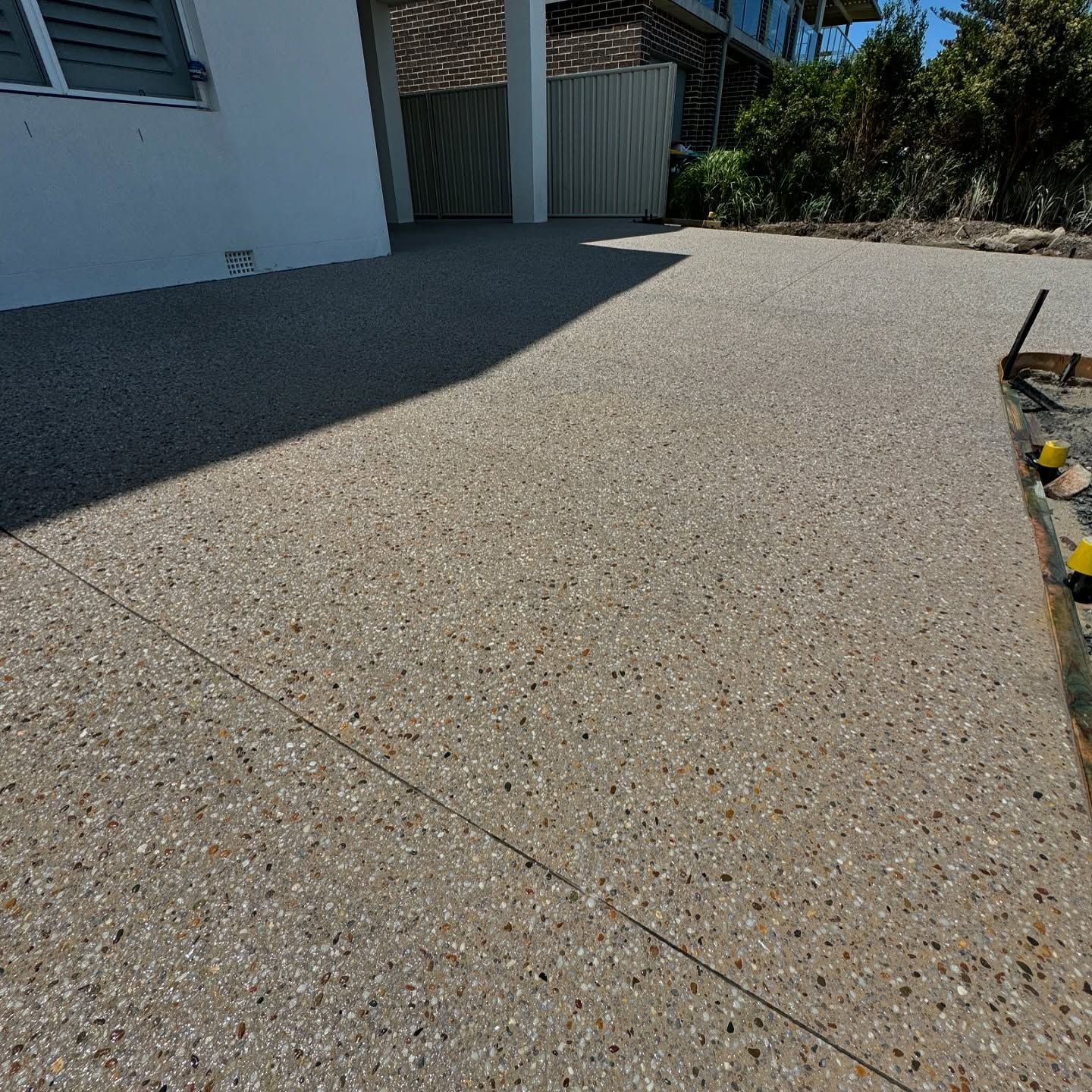 An Outdoor Patio or Driveway With Light-coloured Aggregate Concrete Flooring — JDB Concreting in Robertson, NSW