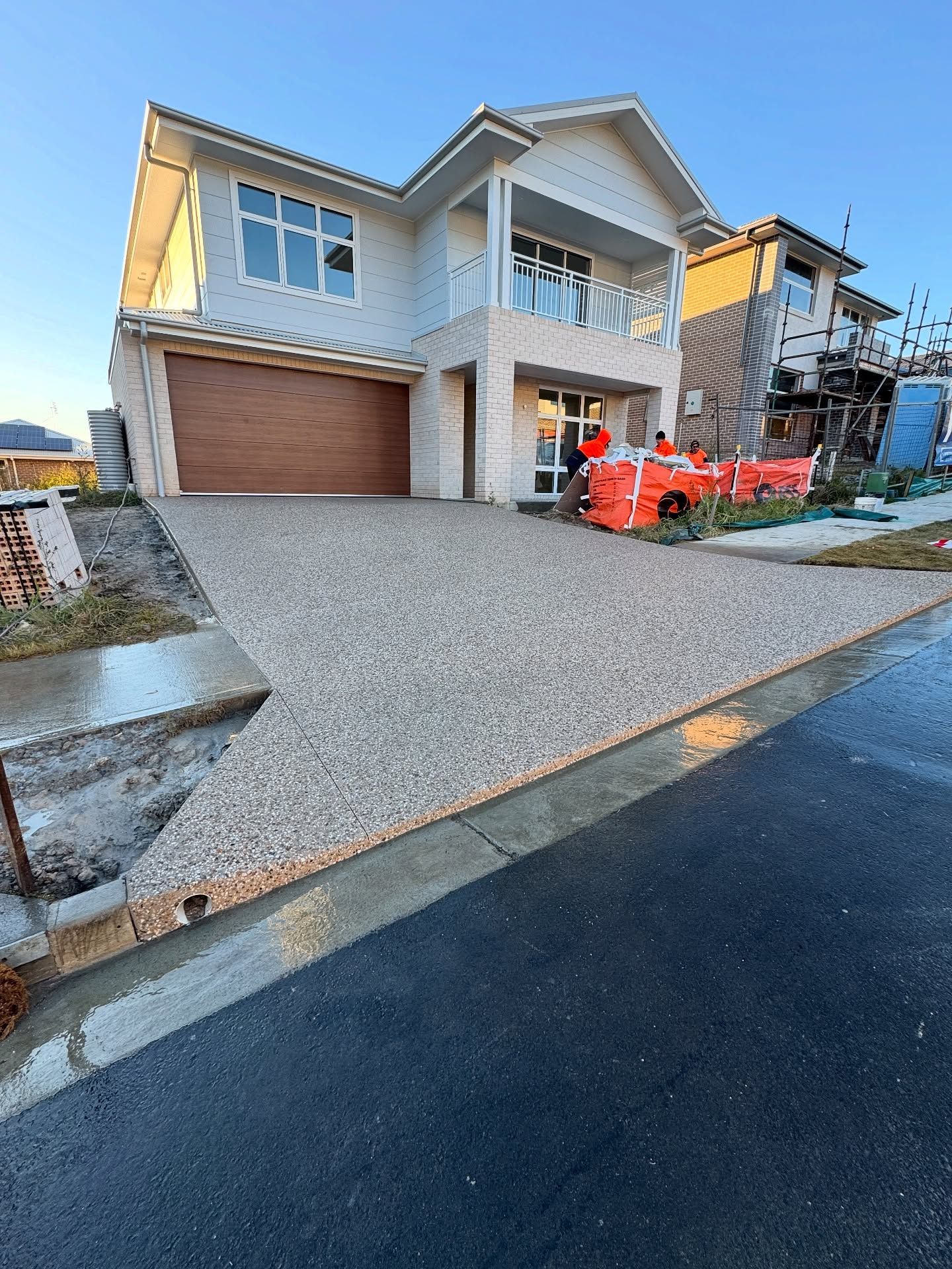 A Newly Built Two-story Suburban House With a Light-coloured Stone Facade — JDB Concreting in Shellharbour, NSW
