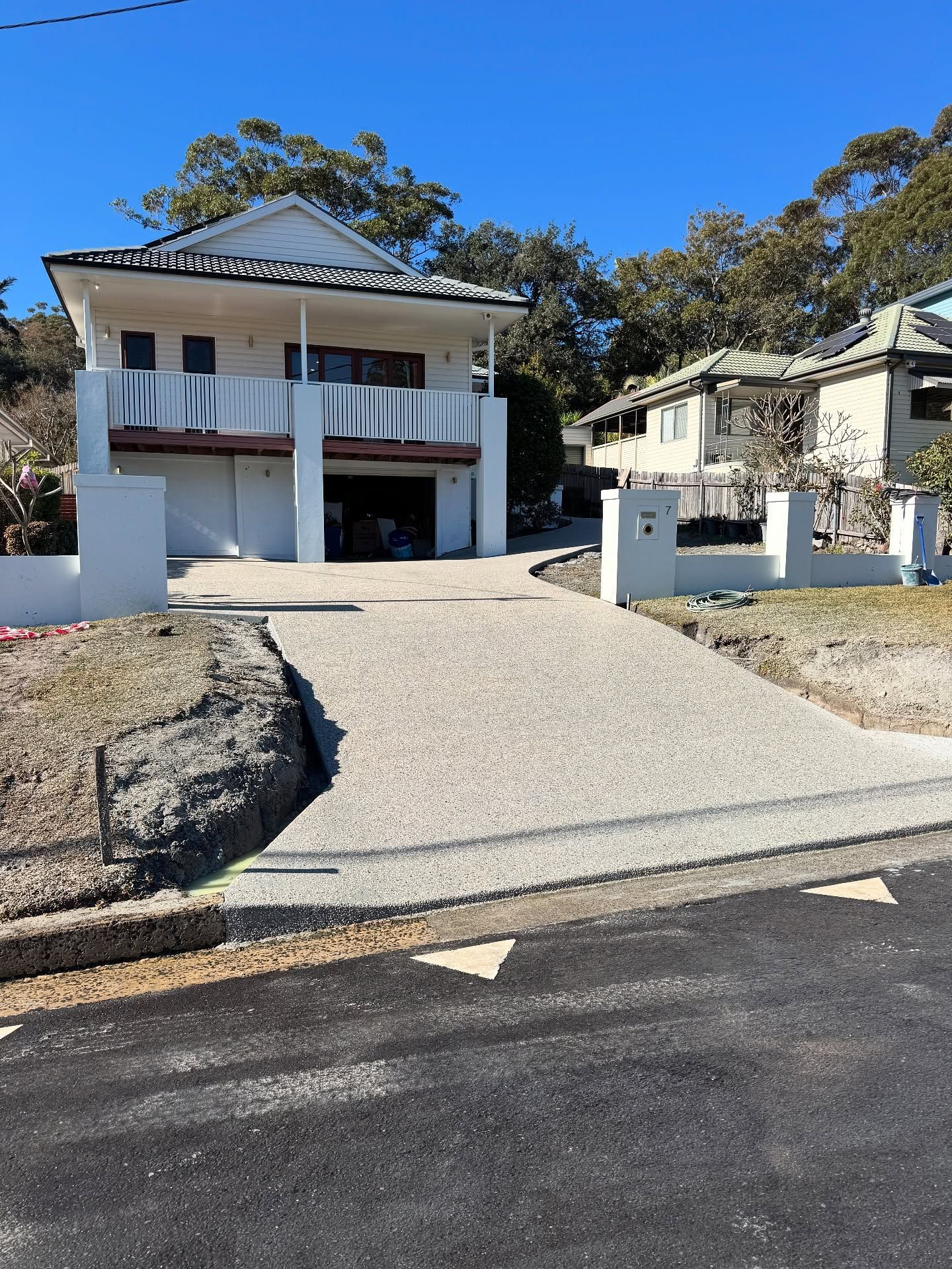 A Two-story White House With a Garage and Balcony — JDB Concreting in Dapto, NSW