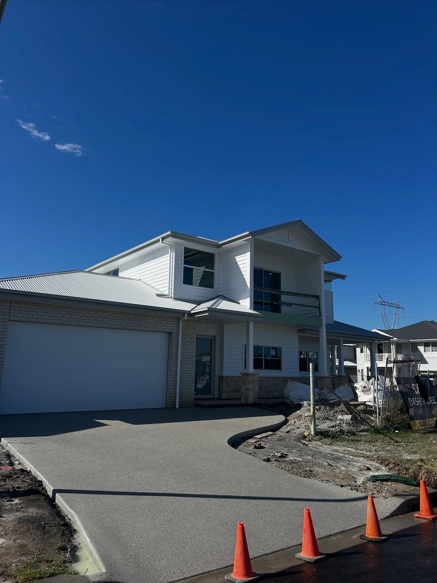 A White, Two-story House Under Construction With an Attached Garage — JDB Concreting in Woonona, NSW