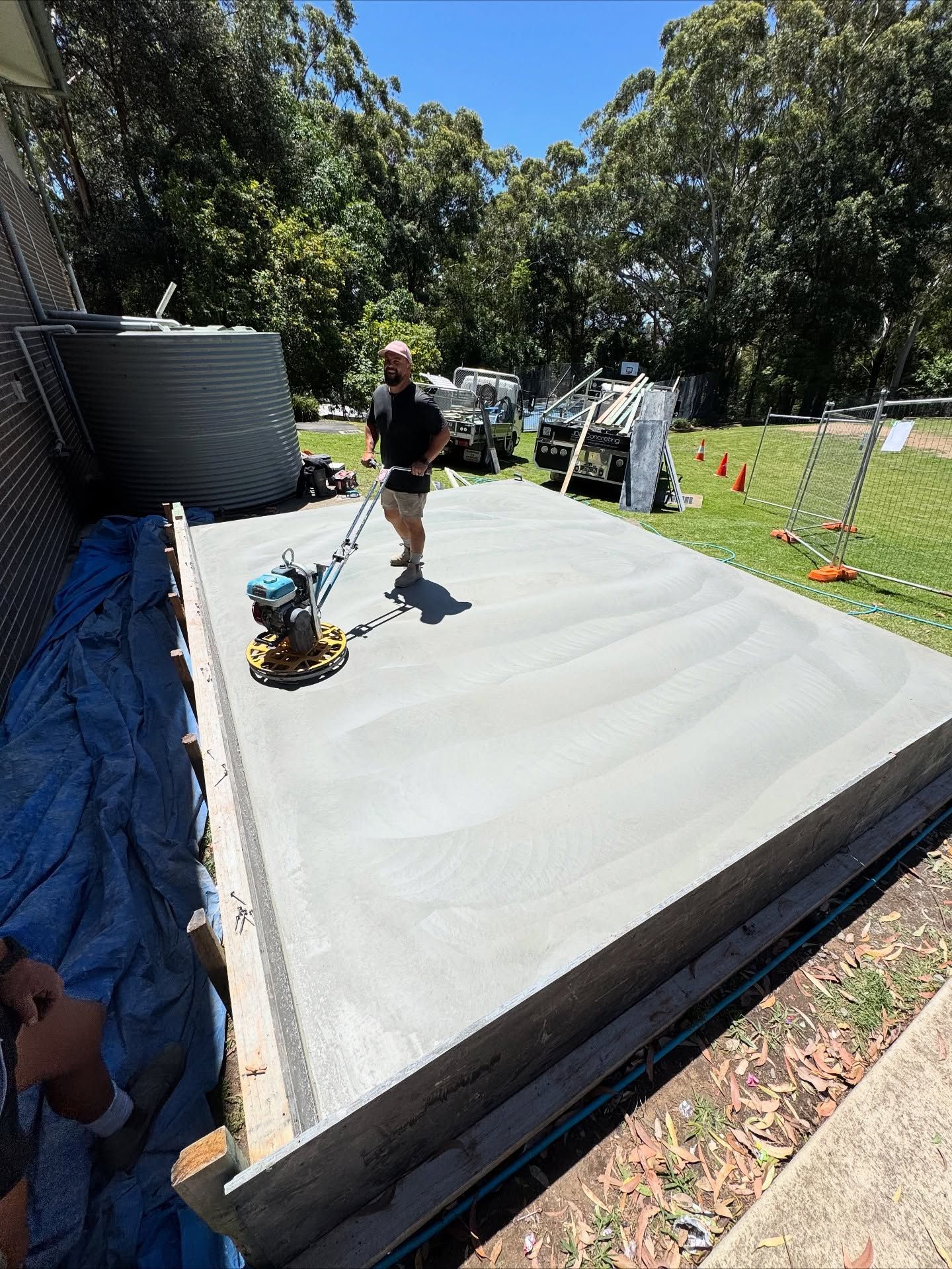 A Person Uses a Power Trowel to Smooth a Freshly Poured Concrete Slab — JDB Concreting in Horsley, NSW

