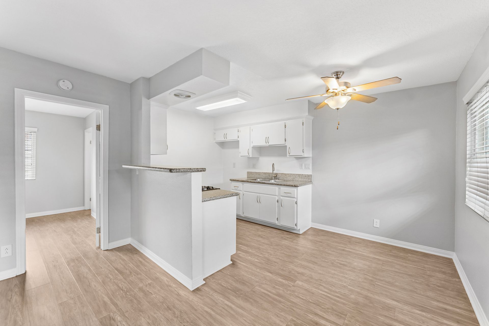 Gallery of exterior and interior photos of Northwind. Including walkways, gray archways, blue front doors, bbq grills, bedrooms with furniture, gated entrances, and main office.