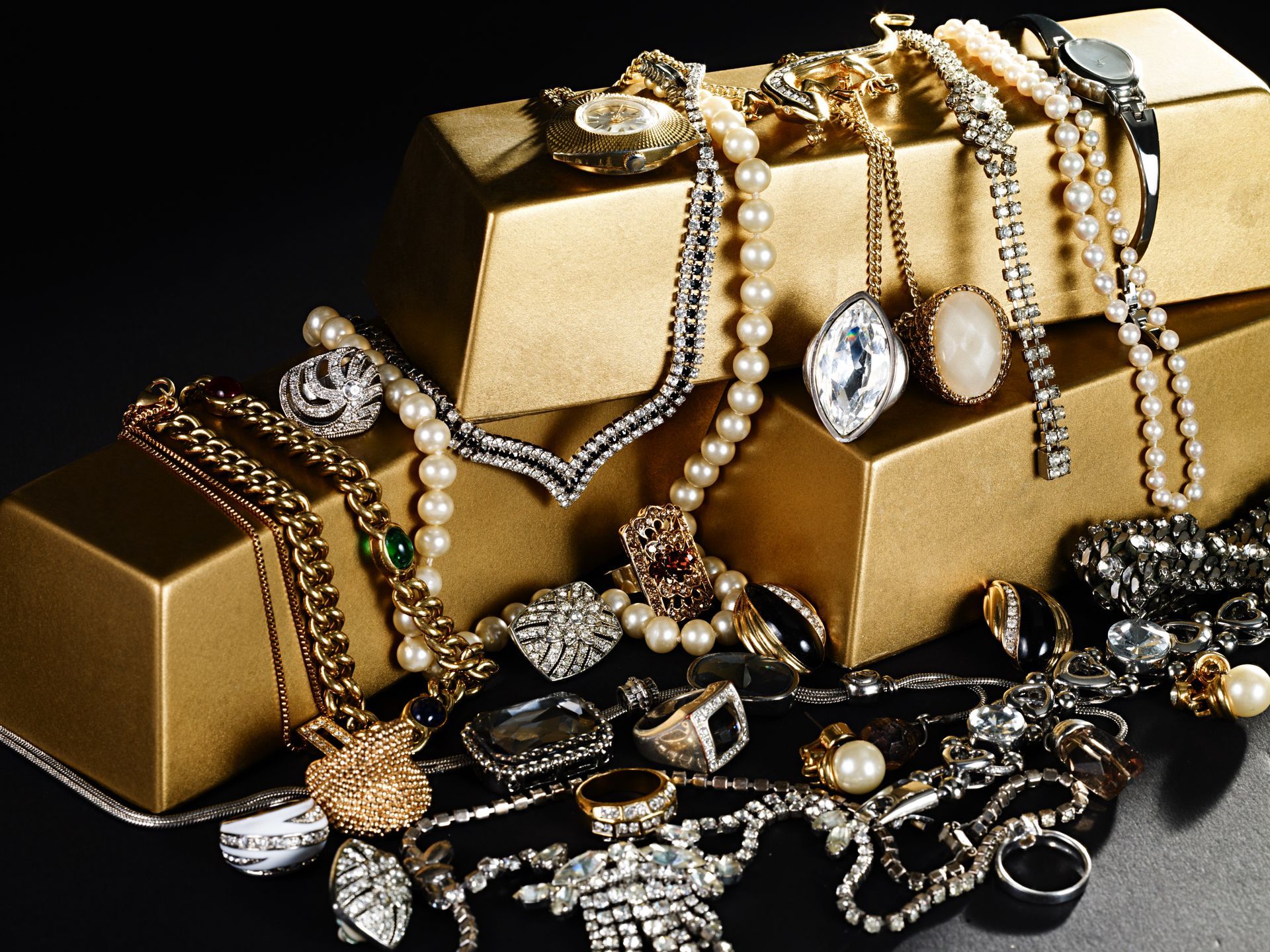 A bunch of jewelry is stacked on top of each other