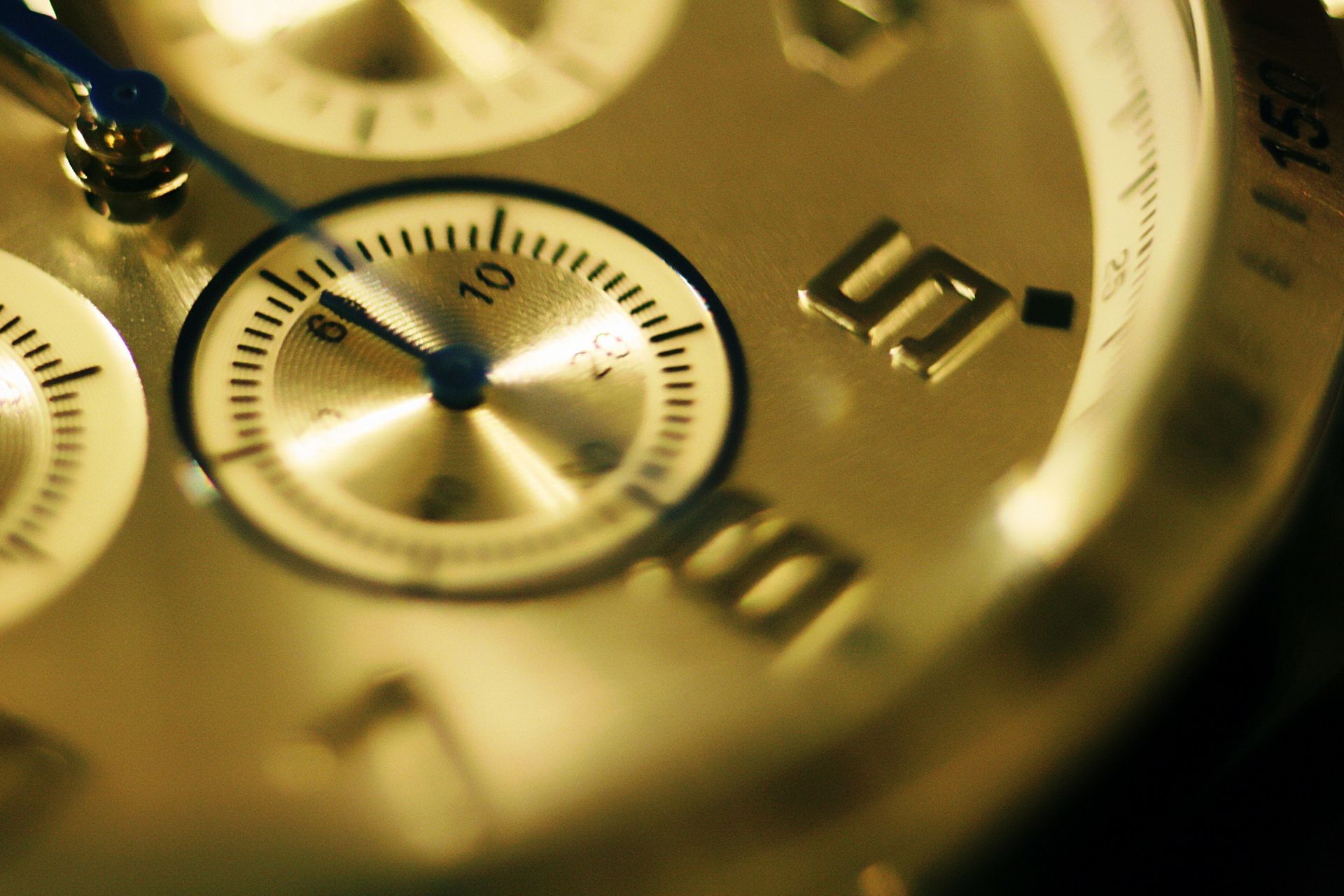 A close up of a watch face with the number 5 on it