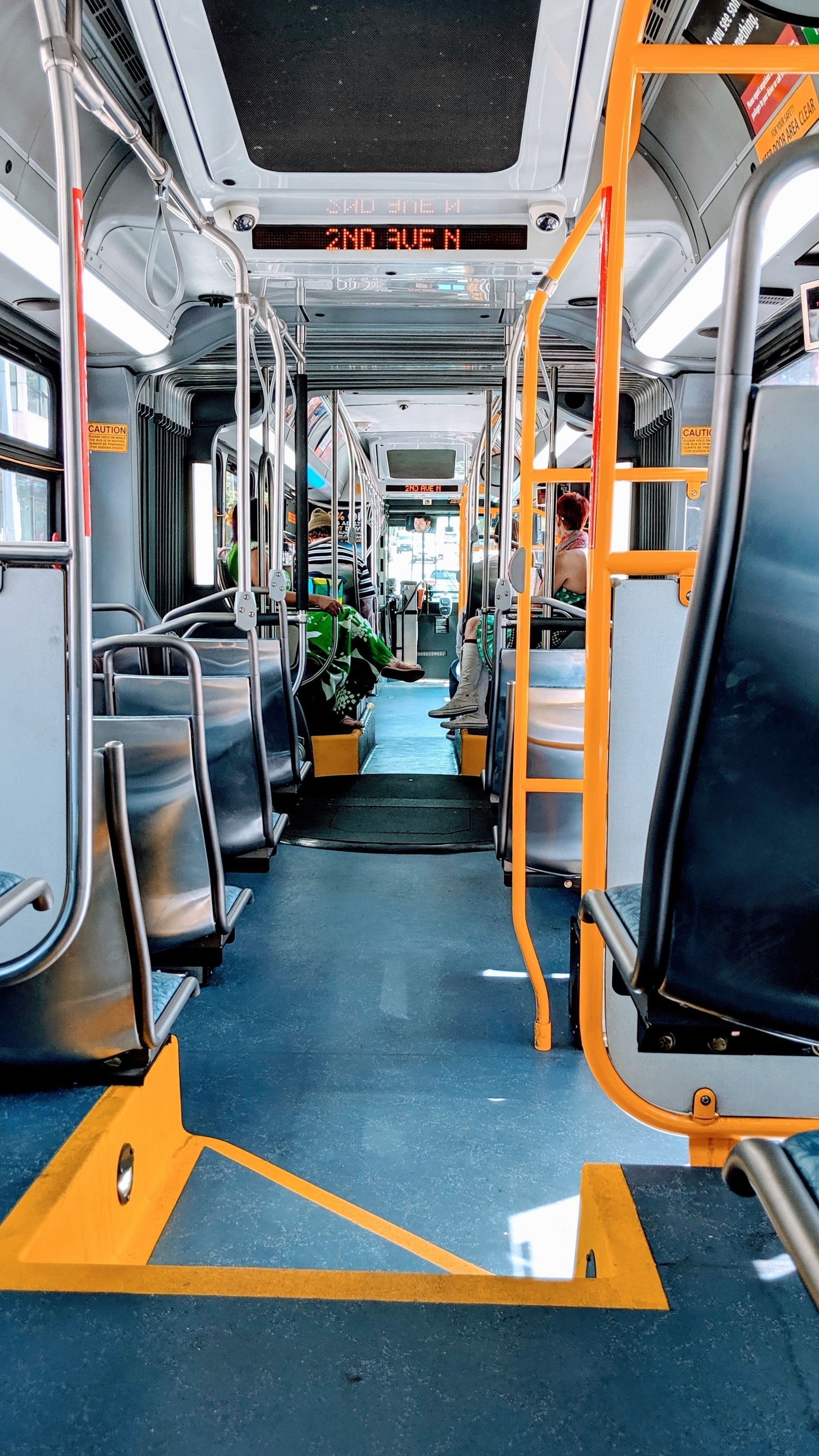 The inside of a bus with a sign that says exit on it.