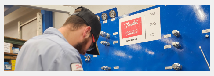 A man is working on a machine in a factory.