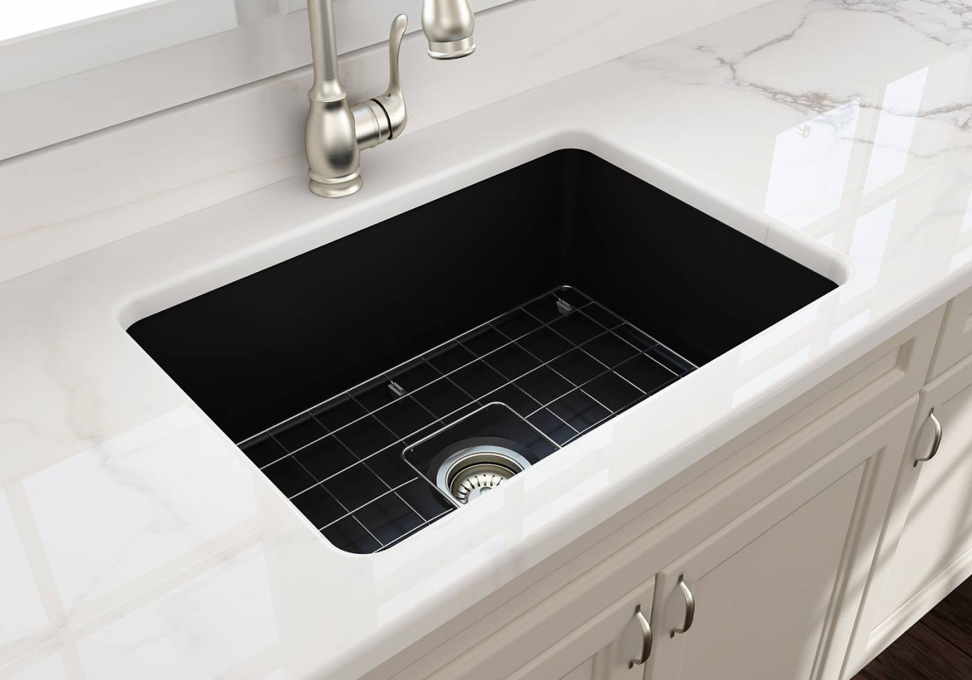 An underbench mounted black butlers sink