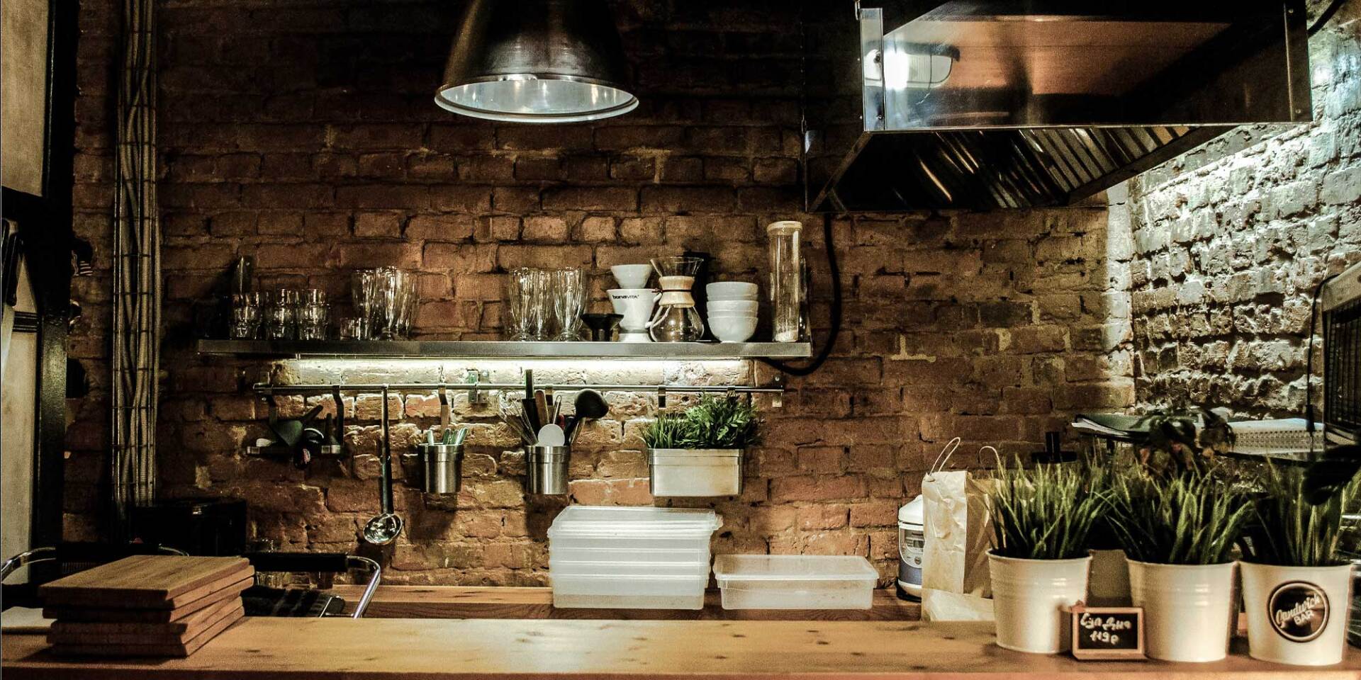 This recycled brick wall serves as a great backsplash for this rustic kitchen.