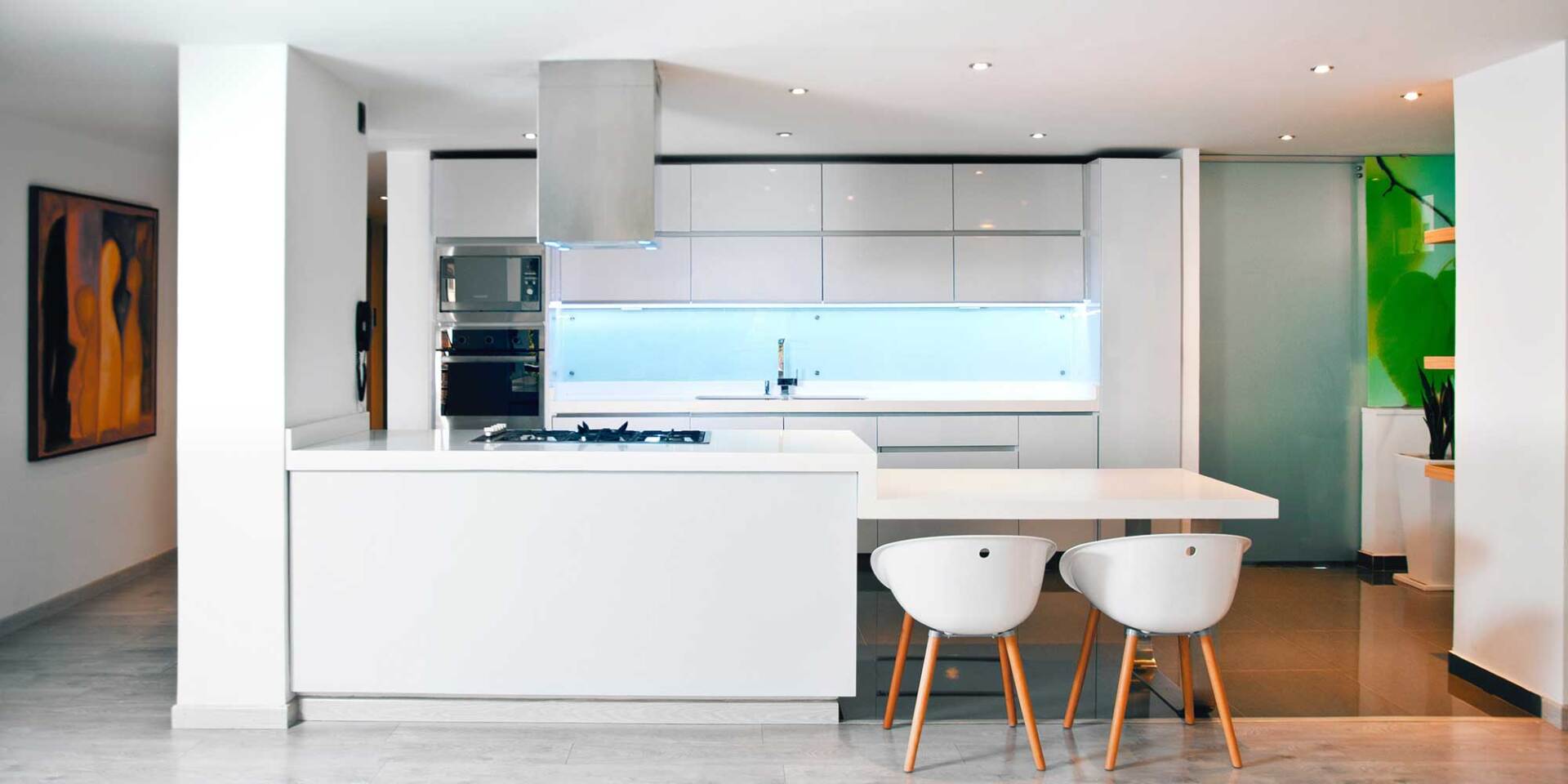 Slimline white kitchen with a blue glass backsplash