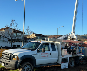 A white truck with a crane on the back of it A white truck with a crane on the back of it
