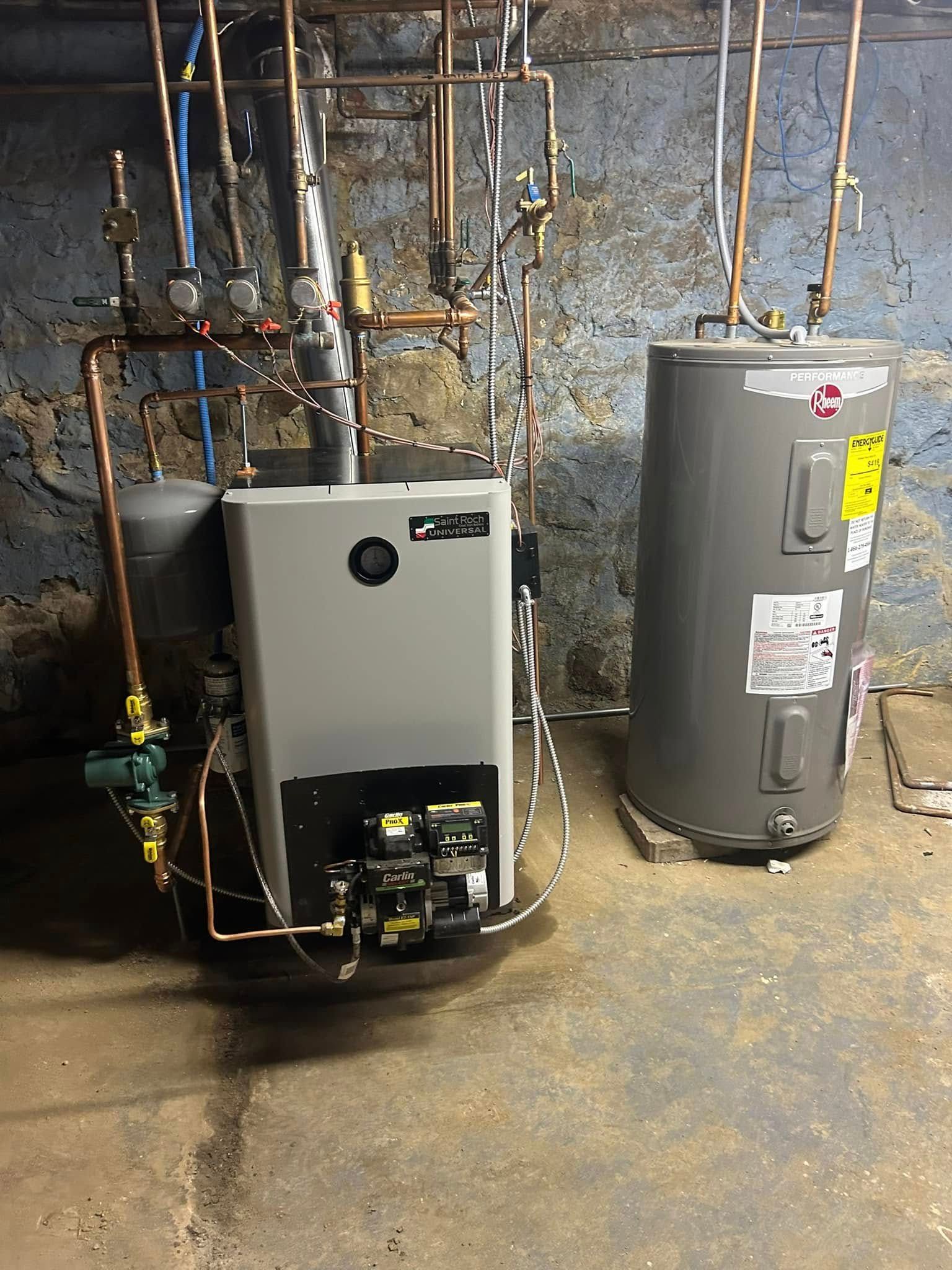 Two water heaters are sitting next to each other in a basement.