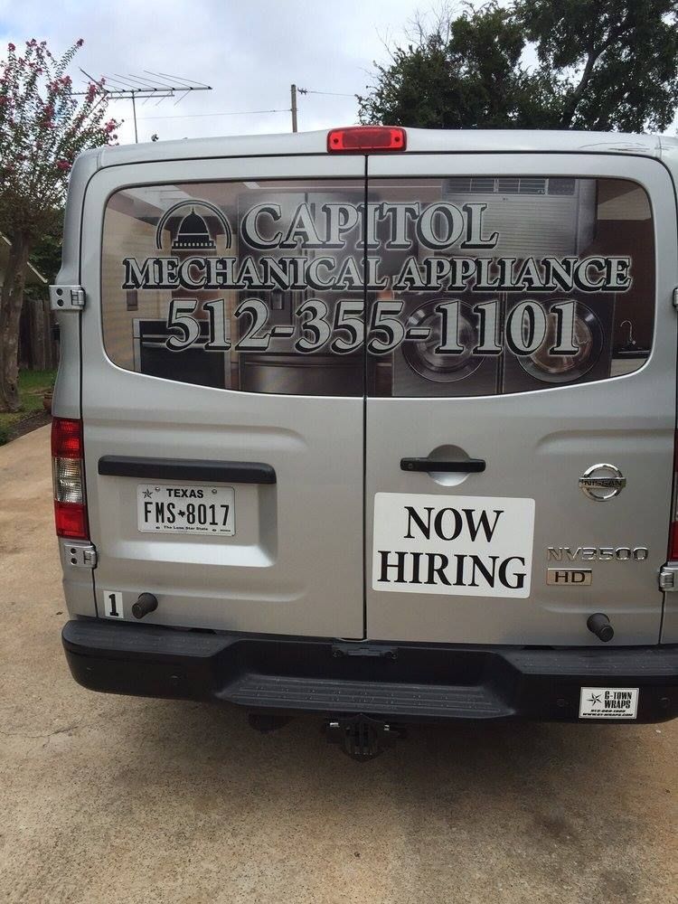 Back of a silver Nissan van with