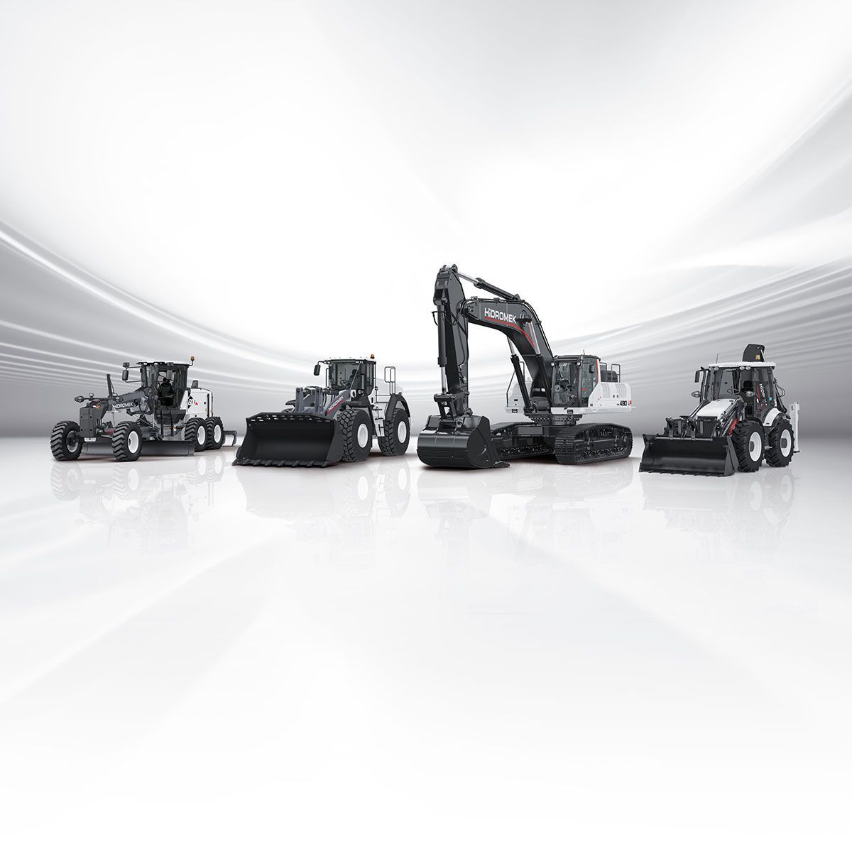 A group of construction vehicles are lined up in a row on a white surface.