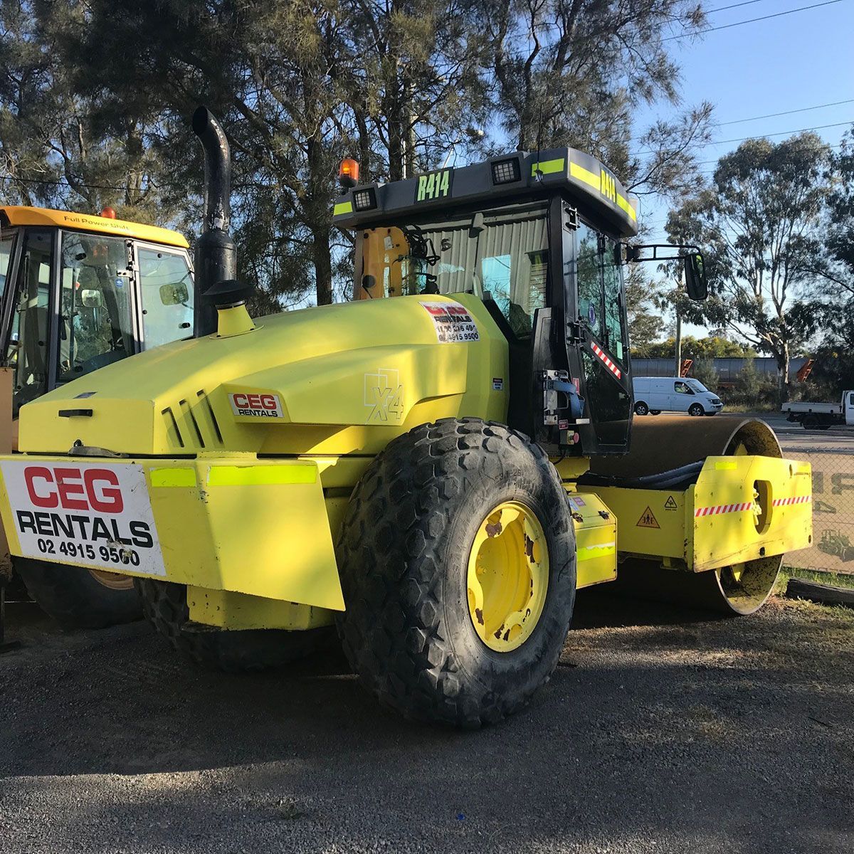 A yellow tractor that says ceg rentals on it