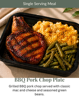BBQ pork chop plate with mac and cheese and green beans in a black tray